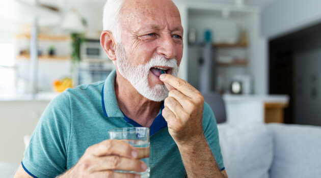 A male senior taking a supplement