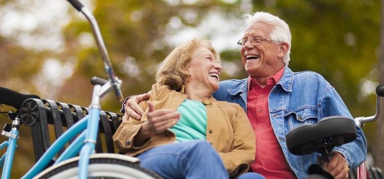Happy senior couple sitting on a bench.
