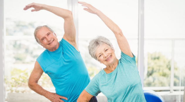 A female and male senior doing a mobility exercise.