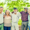 A group of seniors in an outdoor setting smiling.