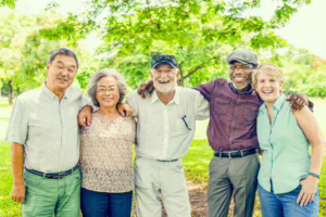 A group of seniors smiling outdoors.