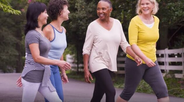 A group of female seniors walking outside.