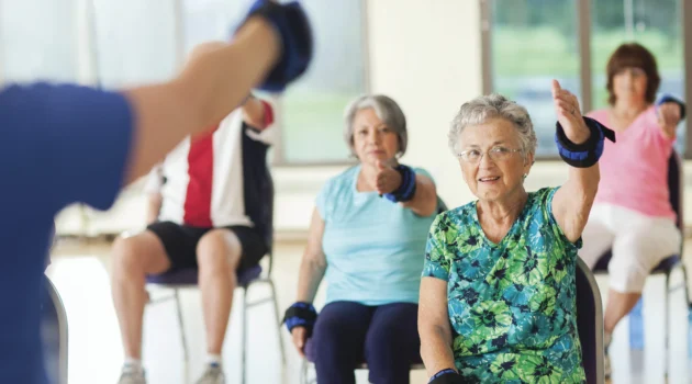 Seniors exercising in a group class setting.