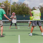 Seniors playing pickleball outdoors