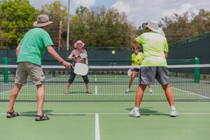 Seniors playing pickleball outdoors